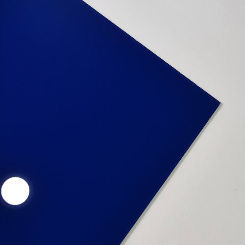 A solid dark blue square sheet or panel shown at an angle against a light gray background, with a small white circular highlight near the lower left edge.